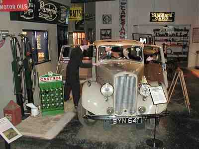 Garage attendant servicing vintage car